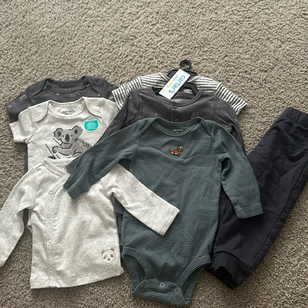 Four onesies, one full outfit, a pair of pants and a shirt